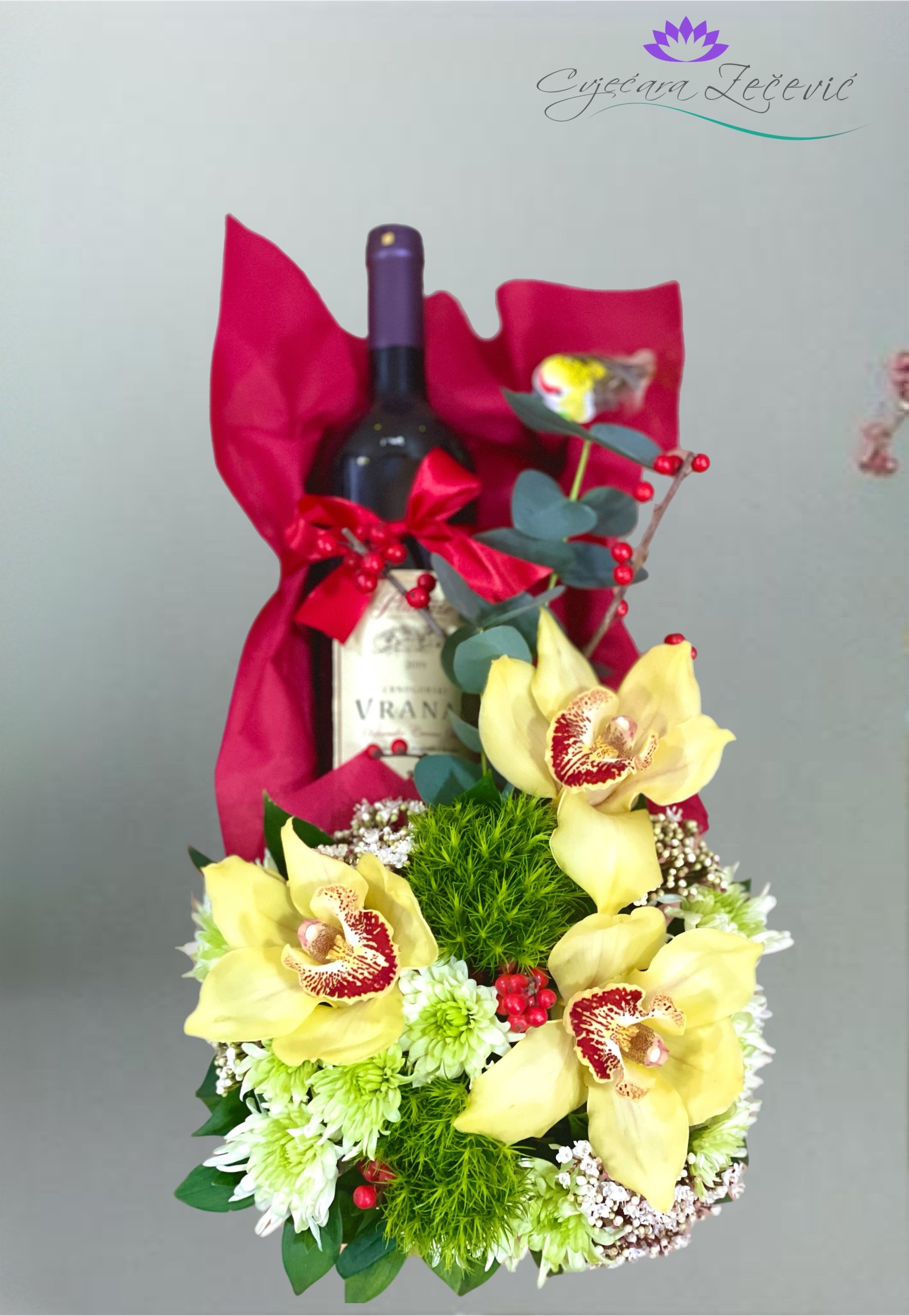 Arrangement with vine and orchids
